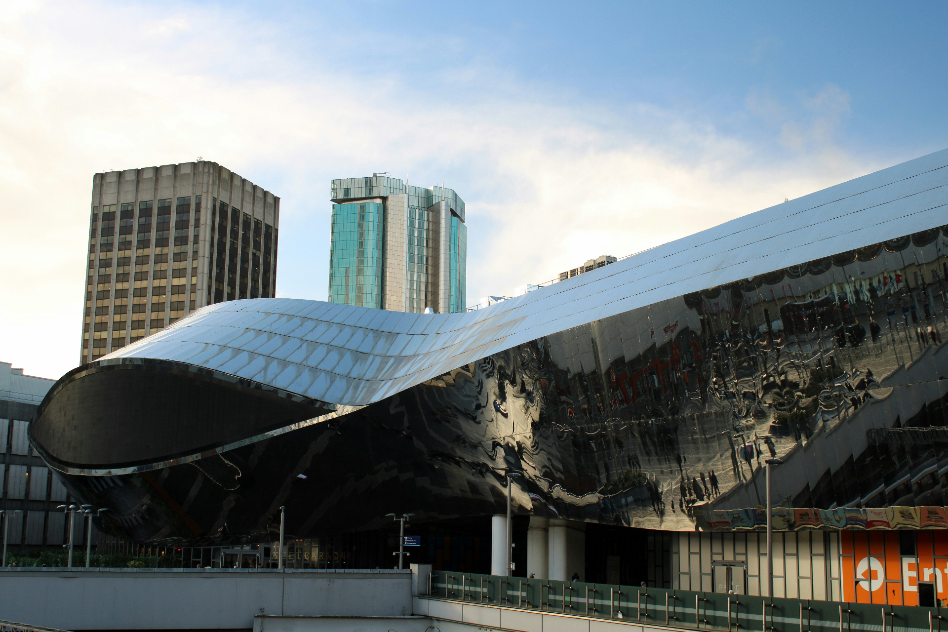 Birmingham New Street Station with the curved reflective Grand Central facade and city skyline